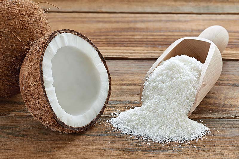 15067313 - close up of a coconut and grounded coconut flakes